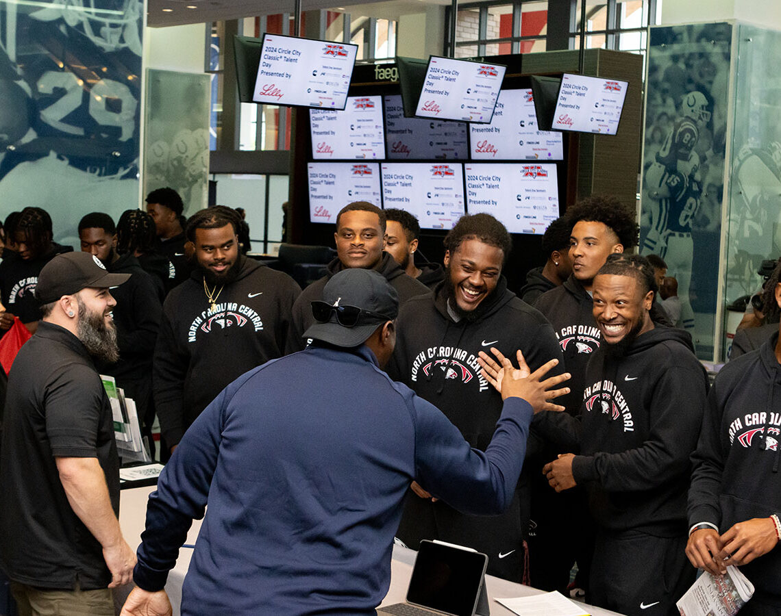 students at fair greeting booth owner